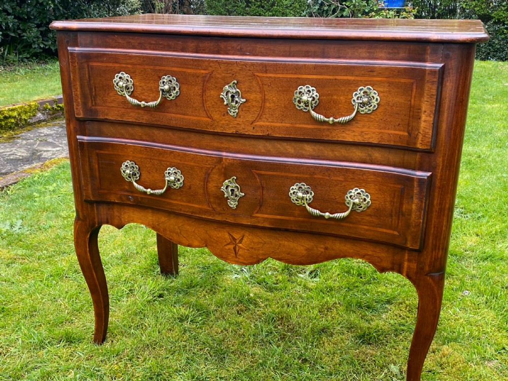 Small walnut serpentine fronted commode 