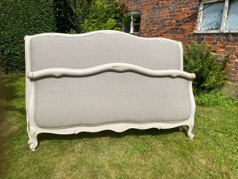 A French Louis XV style upholstered kingsize bed frame with a painted grey timber border and neutral linen fabric panels. View III