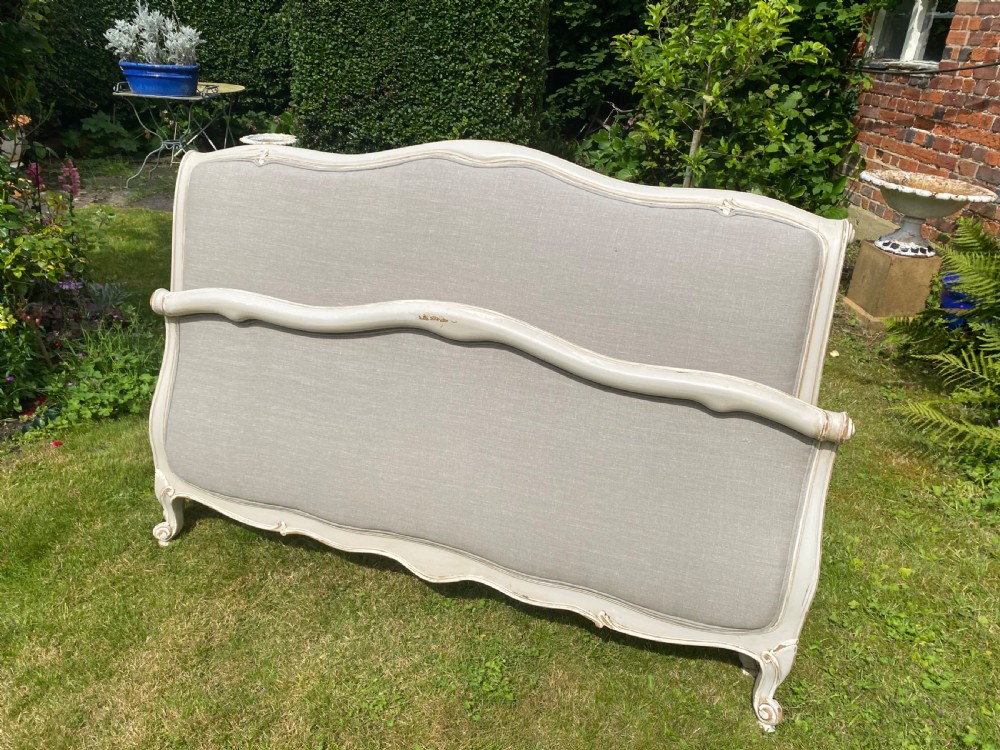 A French Louis XV style upholstered kingsize bed frame with a painted grey timber border and neutral linen fabric panels. View VI