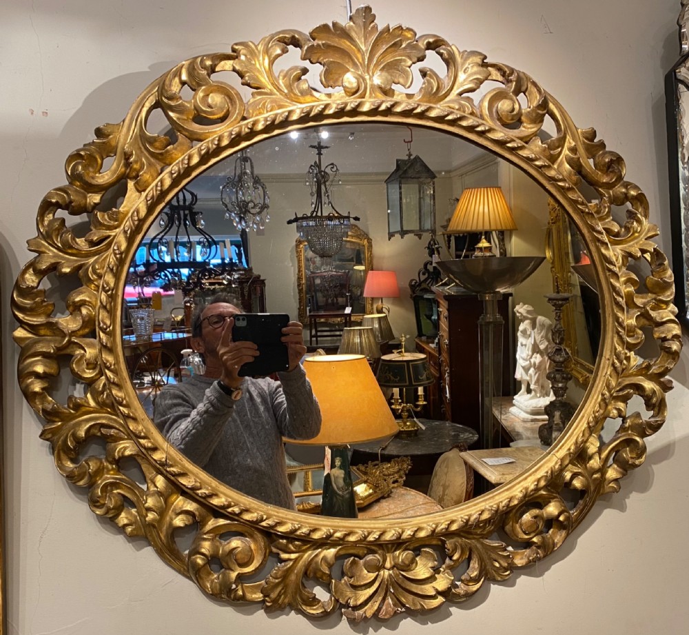 Early carved giltwood oval mirror