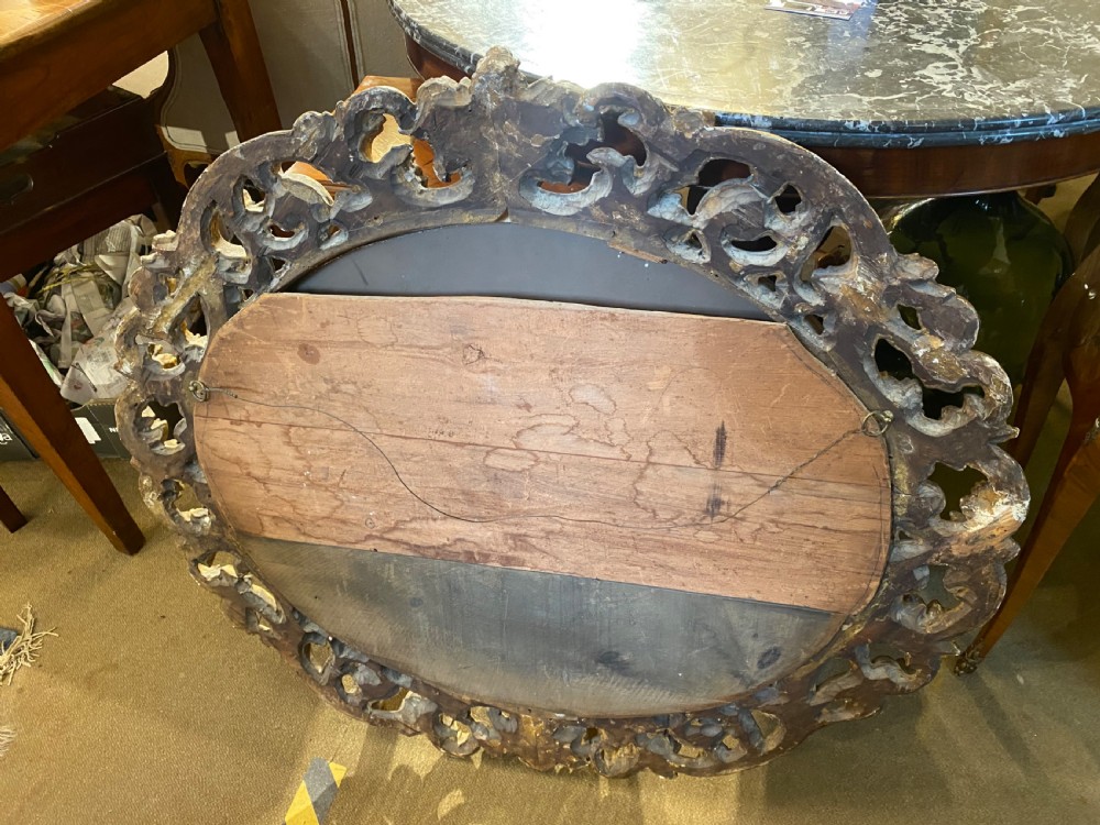 Early carved giltwood oval mirror View V