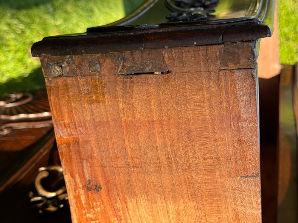 An 18th-century Rococo commode crafted from walnut, featuring two carved drawers with brass handles, cabriole legs, and a scallop shell carved into the lower apron. View VII