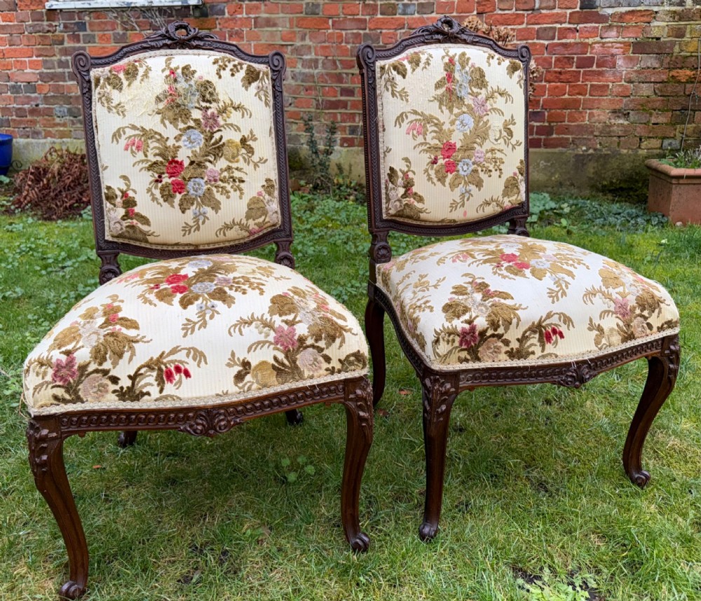 A pair of carved mahogany side chairs featuring cream floral velvet upholstery, cabriole legs, and detailed cresting carvings. View III