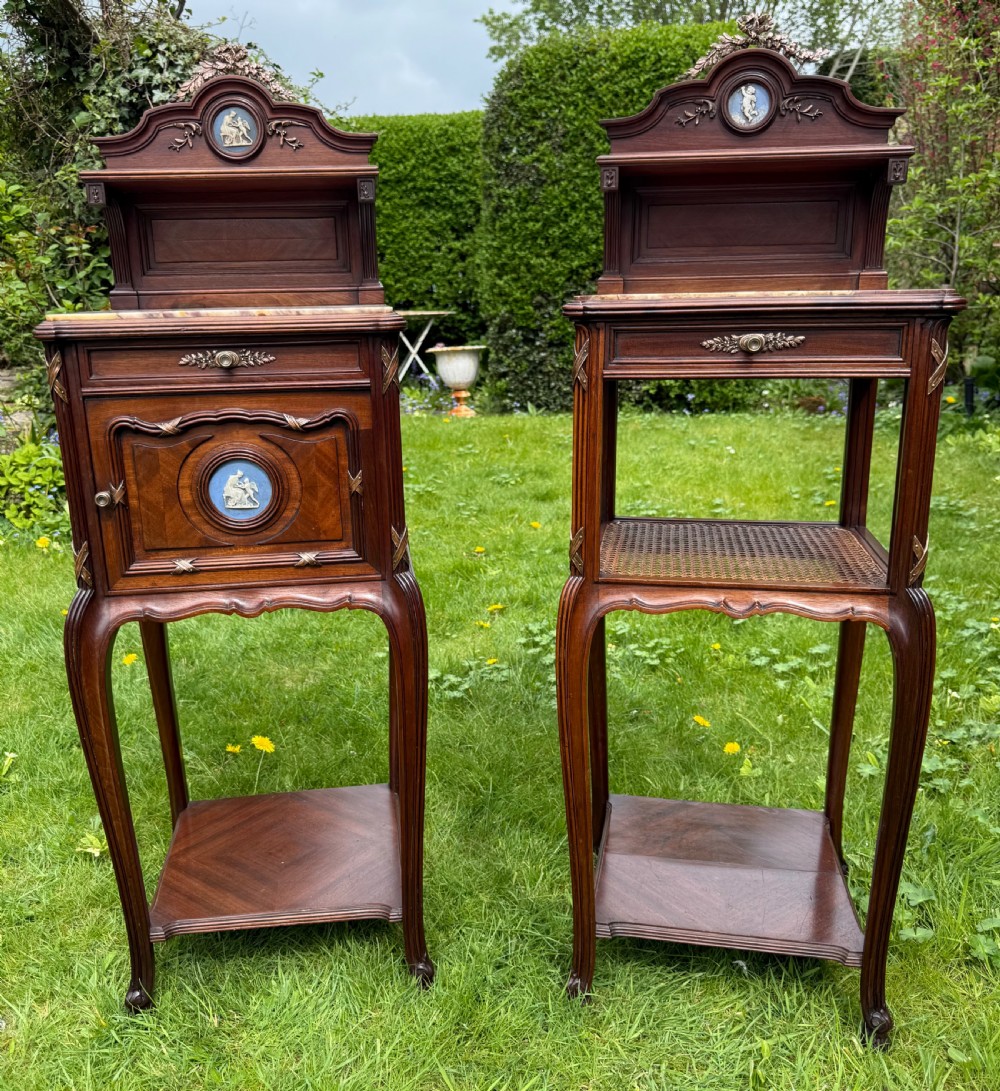 A pair of French Neoclassical wooden bedside tables featuring red marble tops, ceramic medallion inserts, Ormolu mounts, curved legs, and lower open shelves. View III