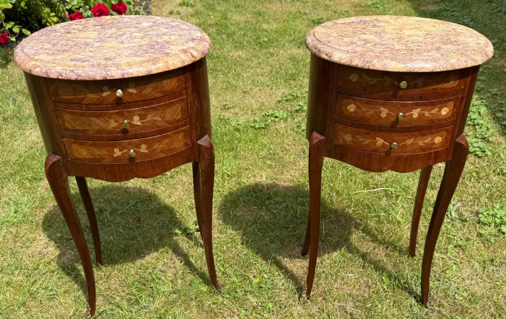 Pair of French oval marquetry bedside tables 