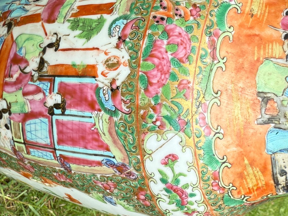 A pair of 19th-century Chinese Famille Rose porcelain vase lamps featuring detailed hand-painted figural scenes, brass mounts, and carved dark wood bases. View V