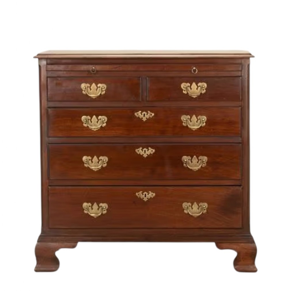 A Georgian mahogany chest of drawers featuring brass swan-neck handles, ornate escutcheons, a brushing slide, two short over three long graduated drawers, and bracket feet.
