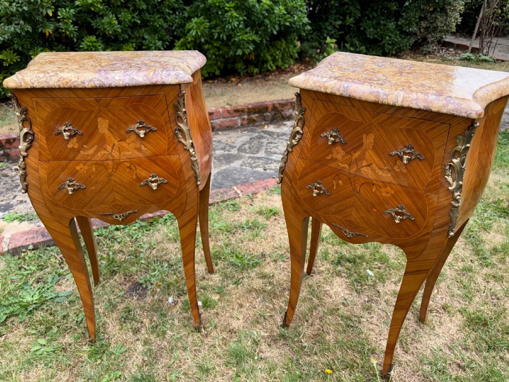 Pair of French Rococo style bedside tables featuring floral wood marquetry, curved cabriole legs, gilt metal mounts, and polished marble tops. View VI