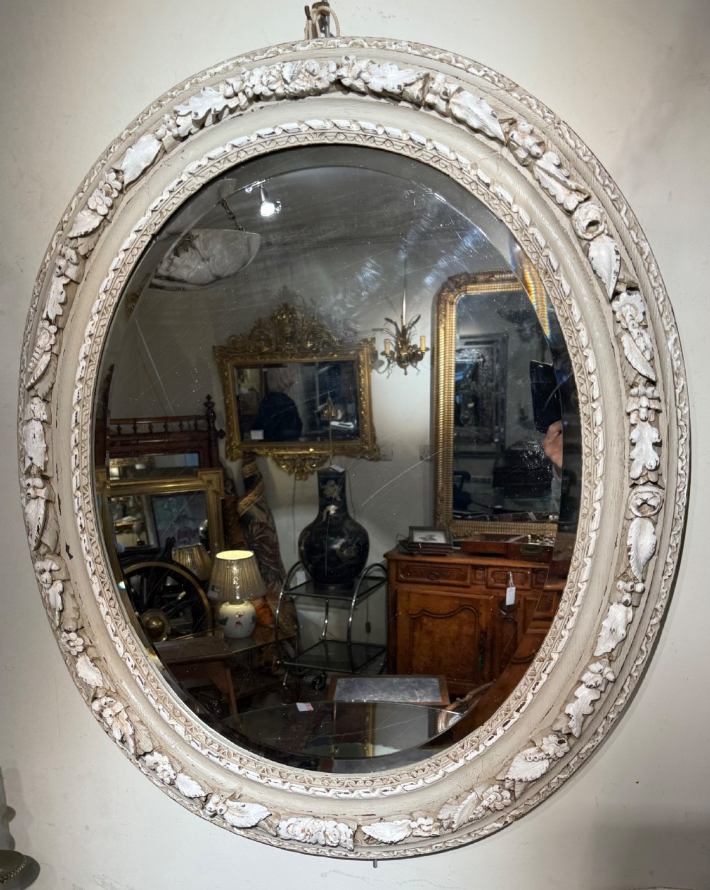 Carved oak oval mirror, later painted in grey and cream colours  View II