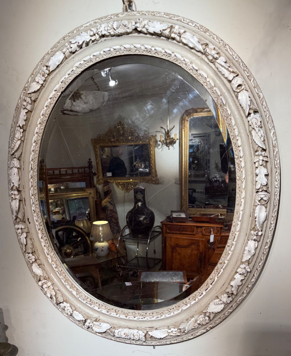 Carved oak oval mirror, later painted in grey and cream colours  View III