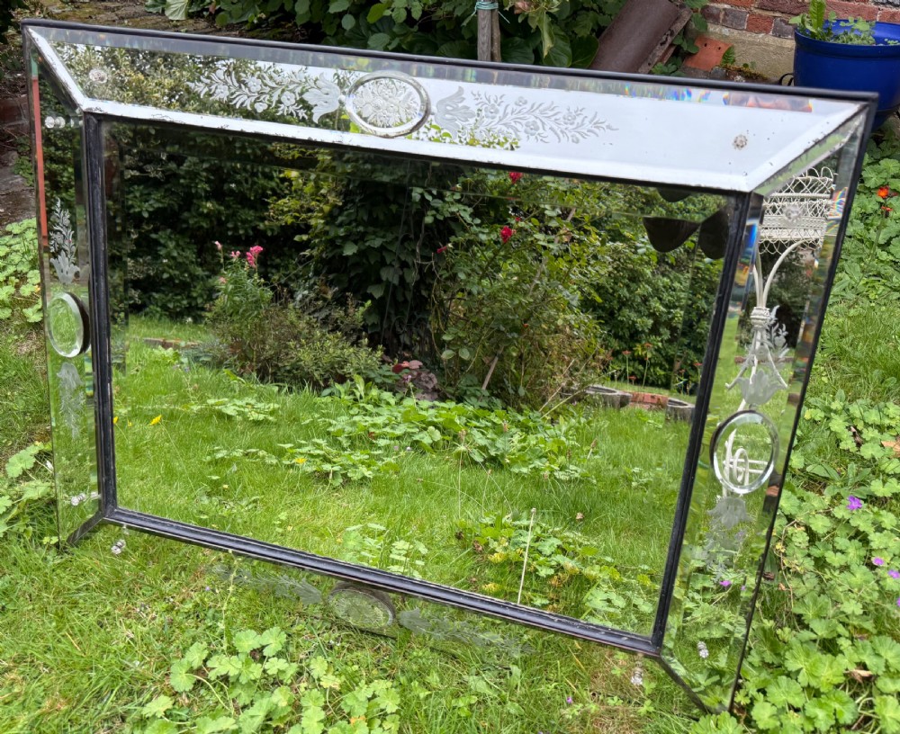 A large rectangular Venetian cushion mirror featuring engraved botanical designs, bevelled edge panels, and decorative glass rosette mountings. View II