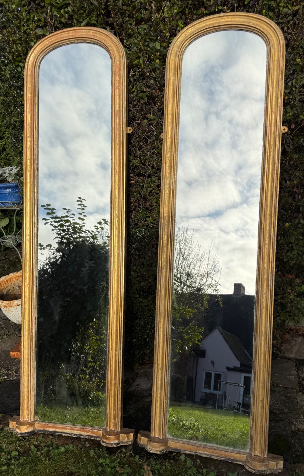 Pair of large 19th Century rubbed gilt mirrors.