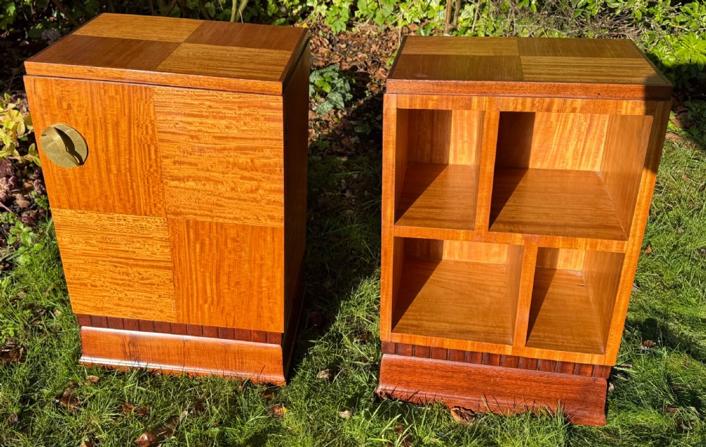 A pair of Art Deco wooden bedside tables featuring checkerboard veneer patterns, with one cabinet unit and one open geometric shelving unit.