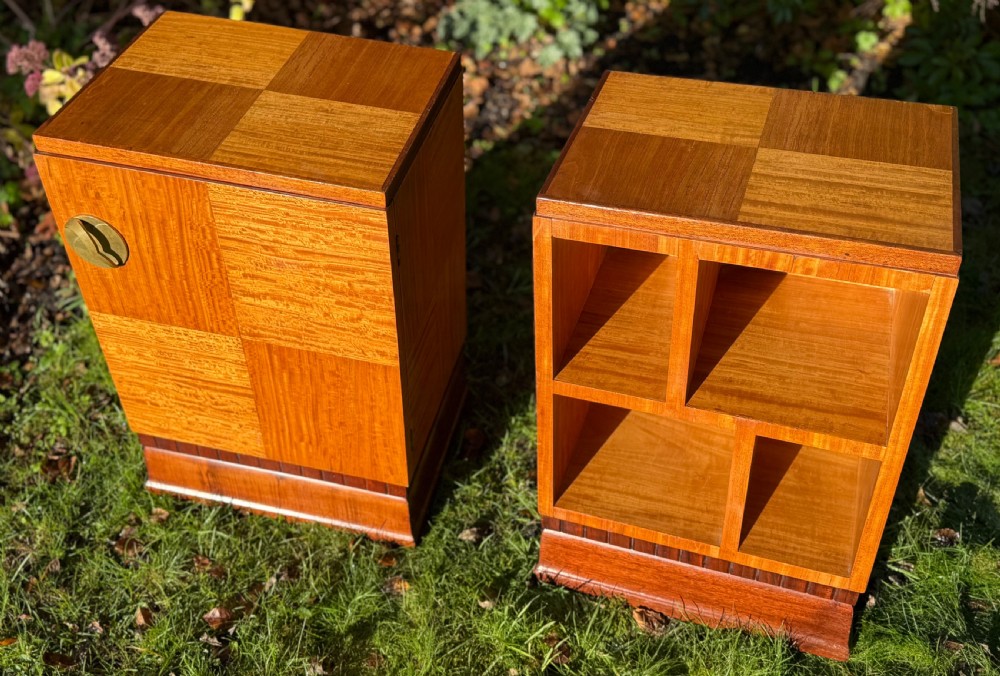 A pair of Art Deco wooden bedside tables featuring checkerboard veneer patterns, with one cabinet unit and one open geometric shelving unit. View II