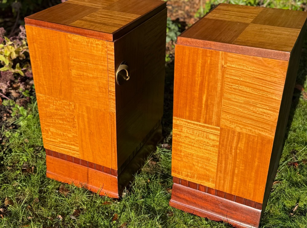 A pair of Art Deco wooden bedside tables featuring checkerboard veneer patterns, with one cabinet unit and one open geometric shelving unit. View III