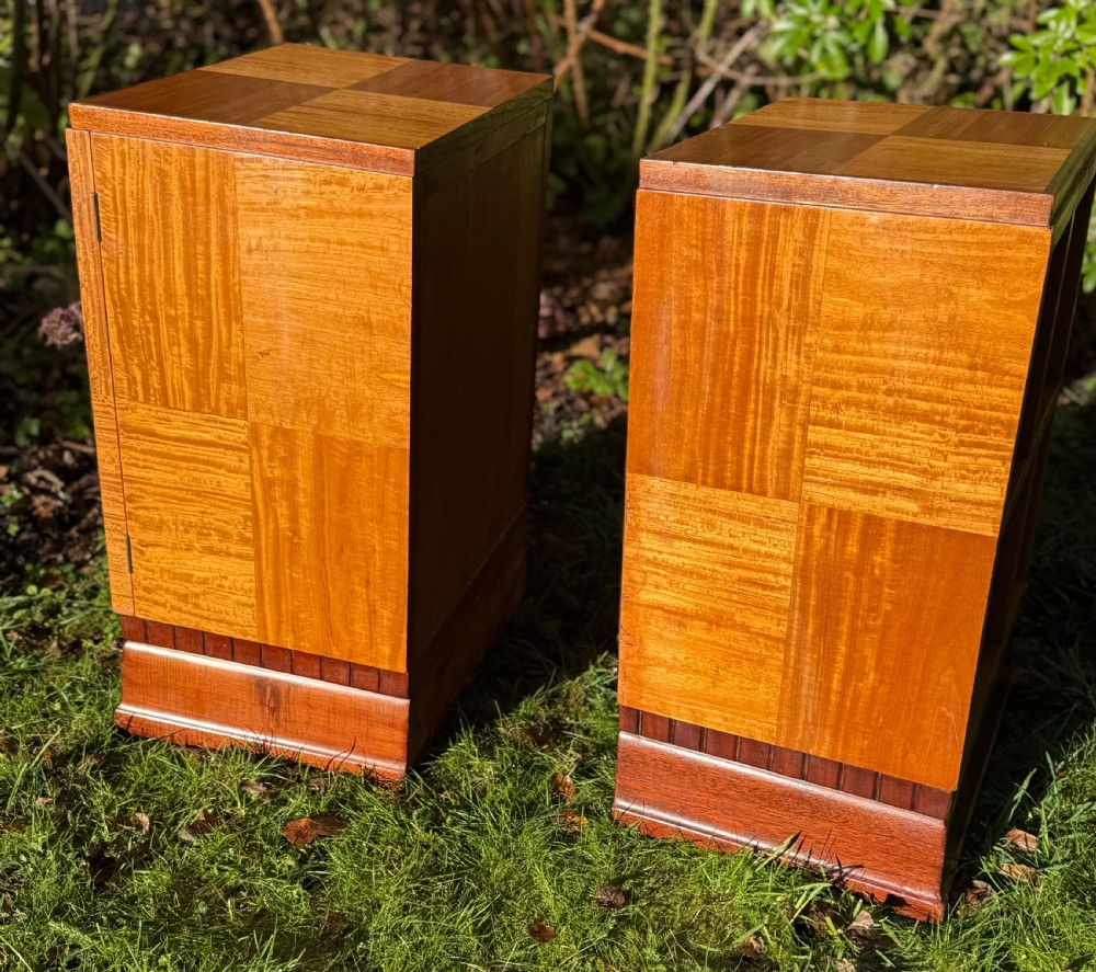 A pair of Art Deco wooden bedside tables featuring checkerboard veneer patterns, with one cabinet unit and one open geometric shelving unit. View V