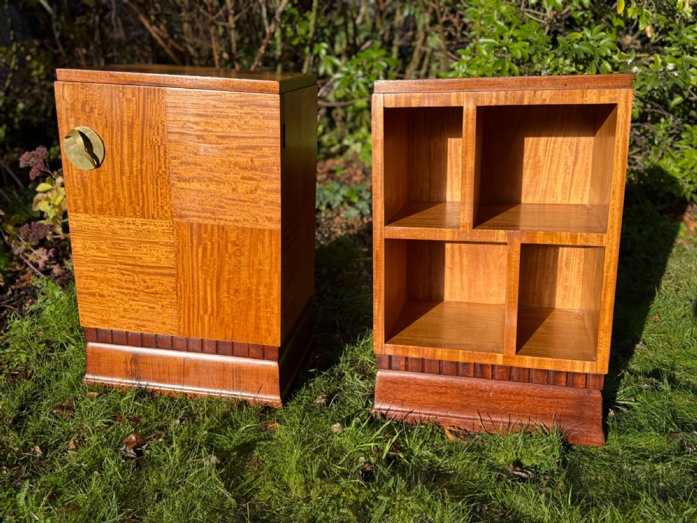 A pair of Art Deco wooden bedside tables featuring checkerboard veneer patterns, with one cabinet unit and one open geometric shelving unit. View VI