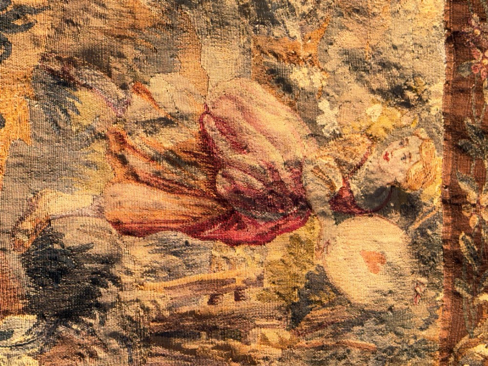 A 19th-century woven wall tapestry depicting a pastoral landscape scene with figures in romantic attire within a detailed floral border. View VIII