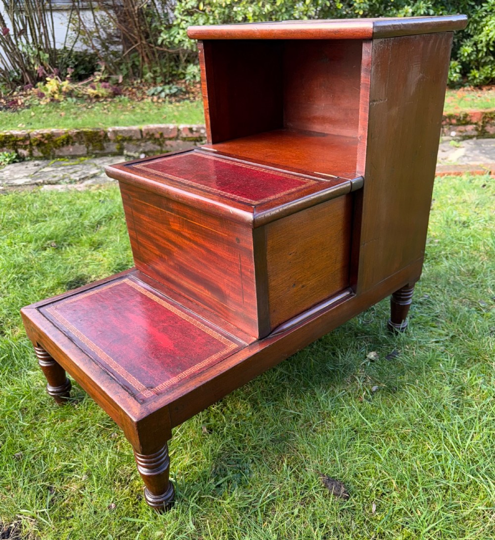 A set of three-tiered Victorian mahogany library steps featuring gold-tooled red leather inserts on the treads and turned wooden front legs. View III