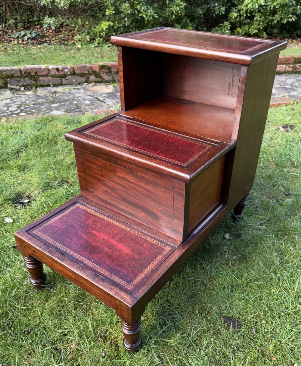 A set of three-tiered Victorian mahogany library steps featuring gold-tooled red leather inserts on the treads and turned wooden front legs. View IV