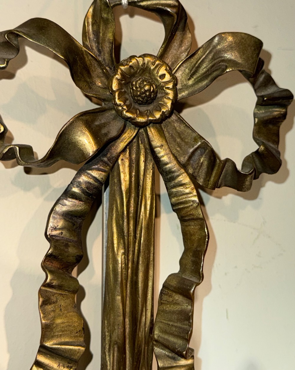 A pair of cast brass three-light wall sconces featuring ribbon bow tops and acanthus leaf scrolled arms. View II