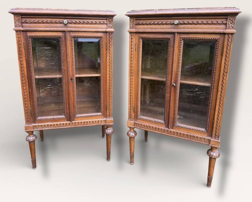 A pair of small walnut glazed cabinets 