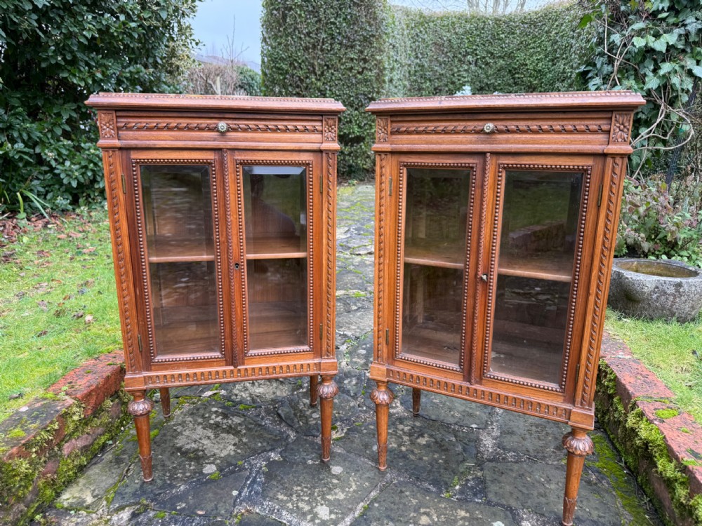 A pair of small walnut glazed cabinets  View III