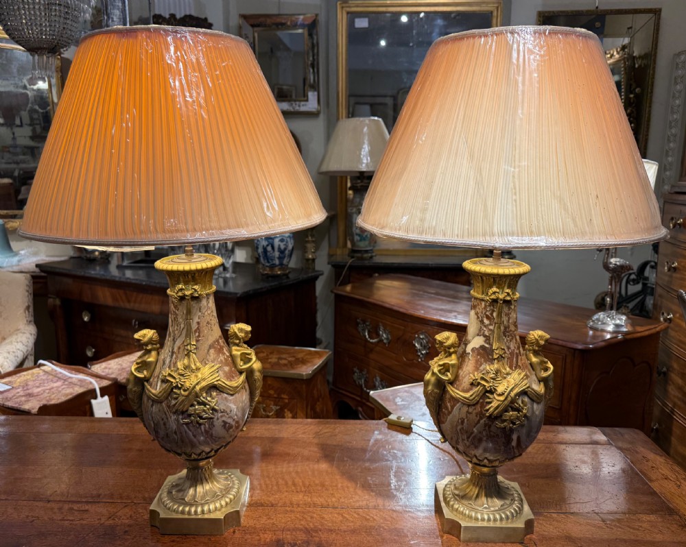 A pair of large table lamps featuring brown veined marble urn-shaped bases adorned with ornate gilt bronze mounts and fitted with pleated fabric shades. View VII