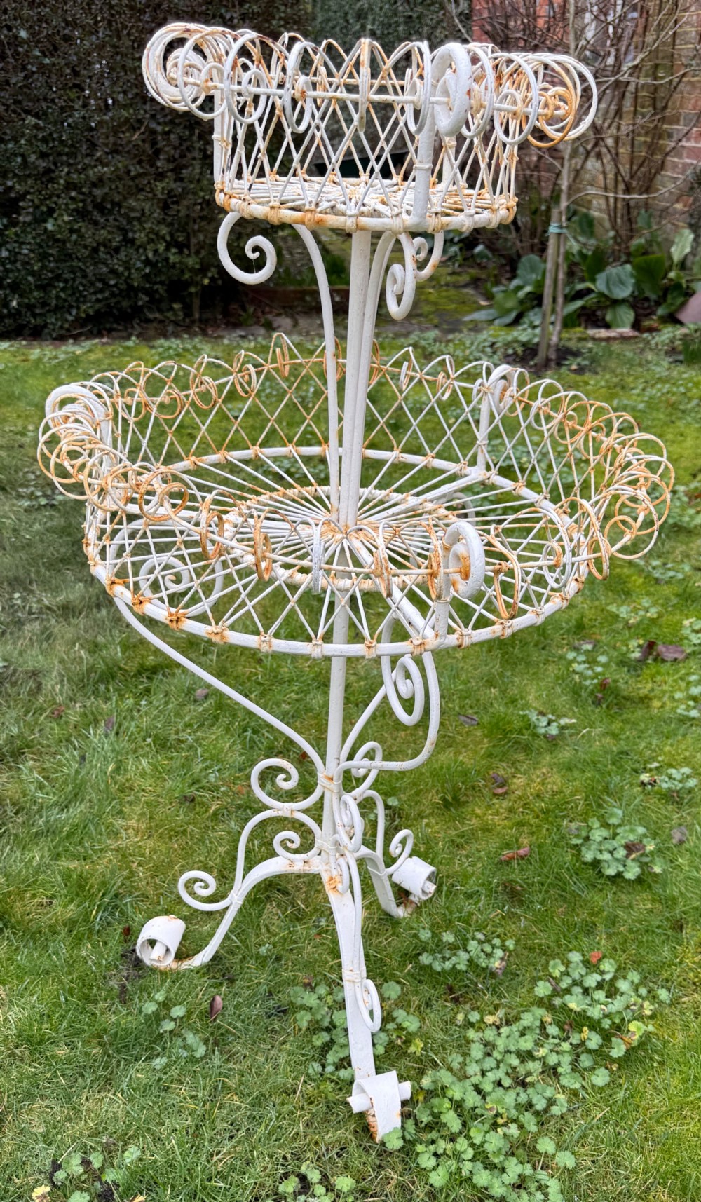 A 19th-century two-tiered white painted iron wirework jardiniere featuring intricate lattice patterning and scrollwork legs. View IV