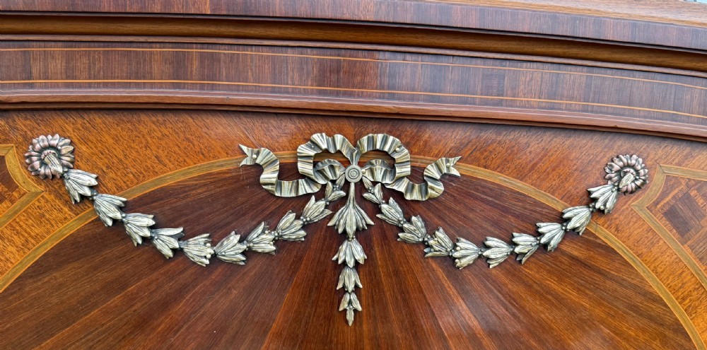 A French Louis XVI style kingsize bedstead with geometric diamond parquetry wood veneer and cast metal mounts on the headboard and footboard. View III