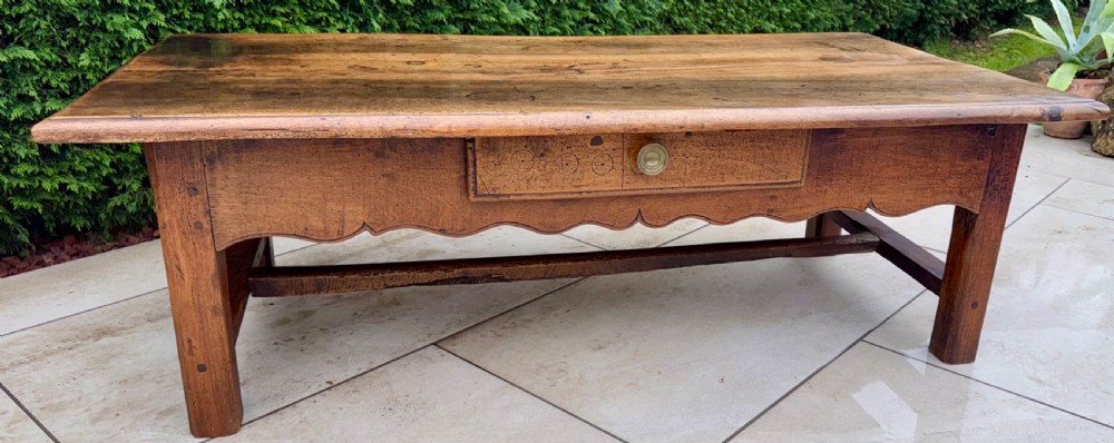 A large 18th-century rectangular walnut coffee table featuring a patinated wood top, a single carved central drawer with a circular brass handle, and a scalloped apron. View VII