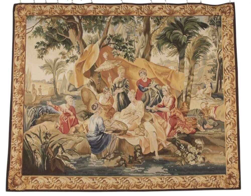 A large rectangular 19th-century French Aubusson style woven tapestry depicting figures under palm trees within a decorative foliage border.