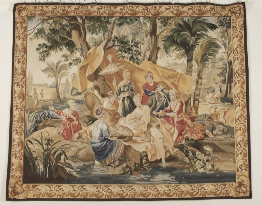 A large rectangular 19th-century French Aubusson style woven tapestry depicting figures under palm trees within a decorative foliage border. View II