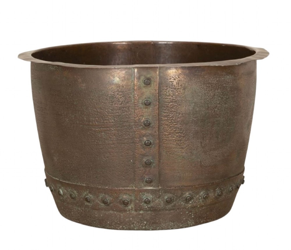 A nineteenth-century circular copper planter with hand-riveted seams, a flared rim, and a patinated coppery-brown surface.