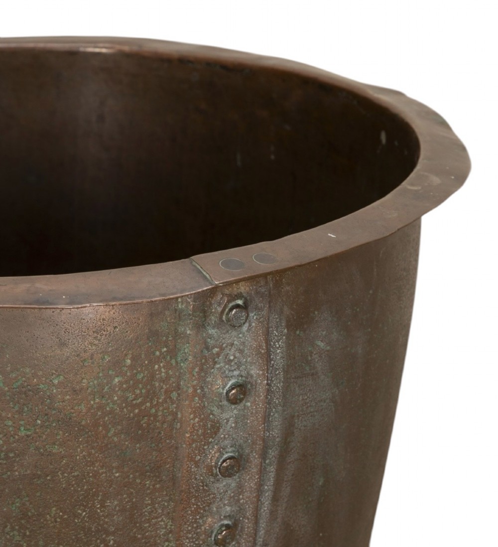 A nineteenth-century circular copper planter with hand-riveted seams, a flared rim, and a patinated coppery-brown surface. View III