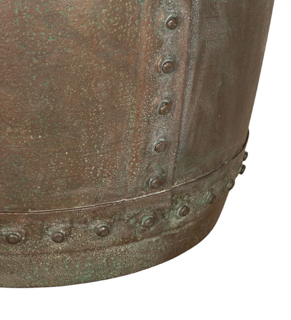 A nineteenth-century circular copper planter with hand-riveted seams, a flared rim, and a patinated coppery-brown surface. View IV