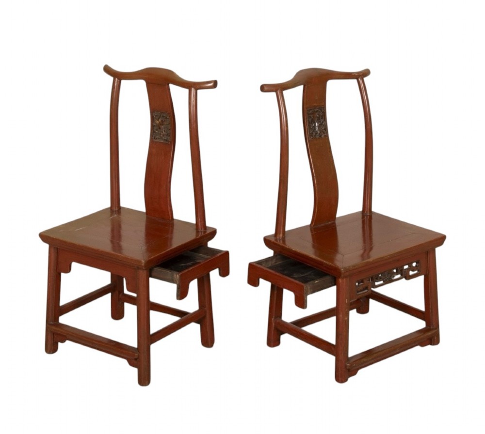 A matched pair of 19th-century Chinese side chairs featuring curved yoke top rails, carved central back splats, square timber seats, and a reddish-brown lacquered finish. View III