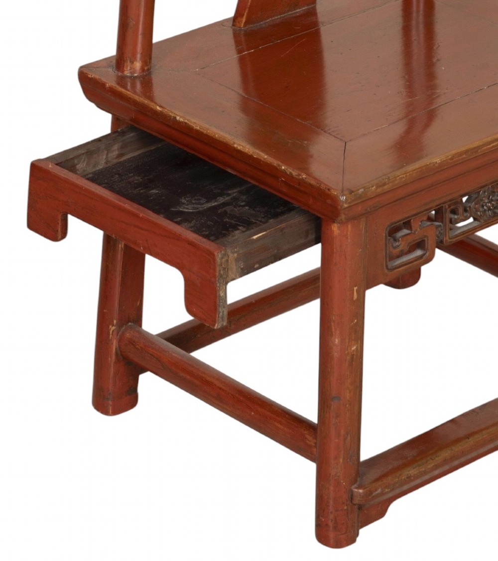 A matched pair of 19th-century Chinese side chairs featuring curved yoke top rails, carved central back splats, square timber seats, and a reddish-brown lacquered finish. View V
