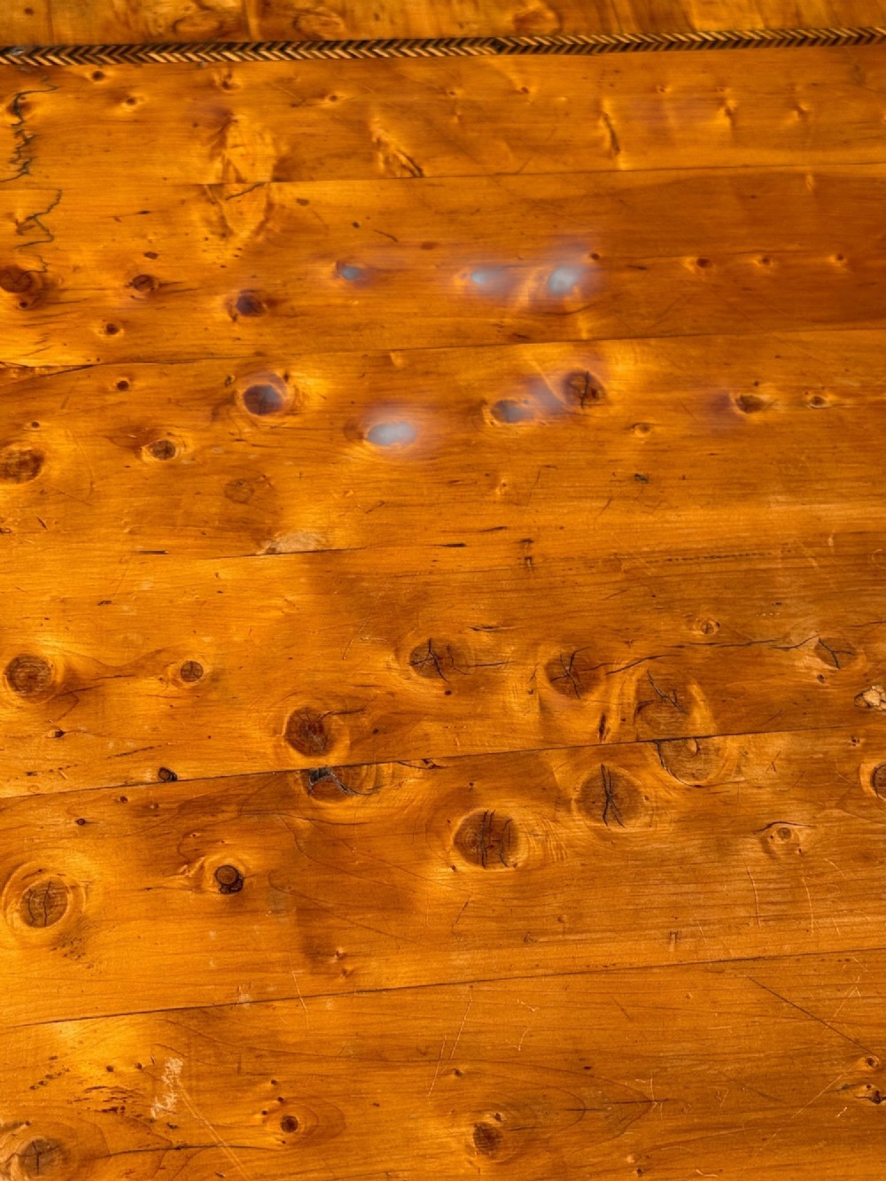 A golden-brown burr wood side table featuring a serpentine-edged top with inlay, a single drawer with a keyhole, and four slender cabriole legs. View III