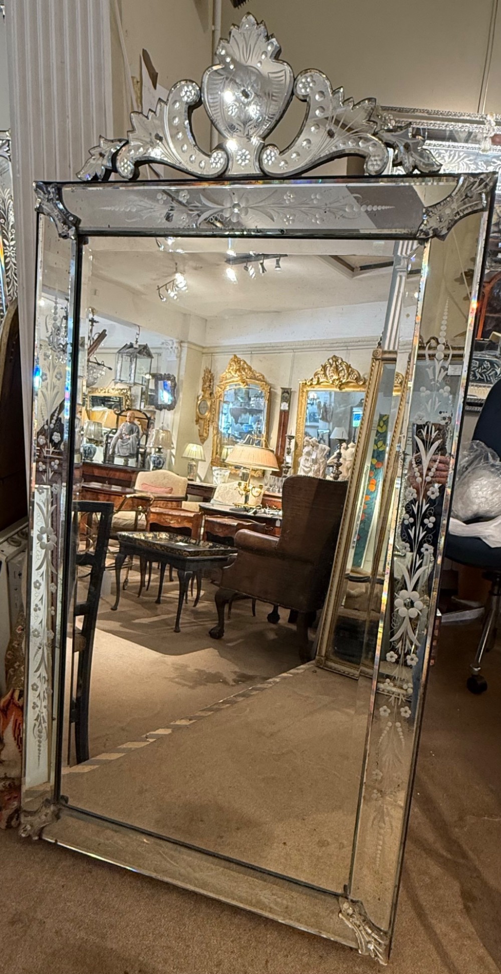 A large rectangular Venetian wall mirror featuring etched floral border panels, bevelled glass edges, and a prominent scrolling glass crest. View VI