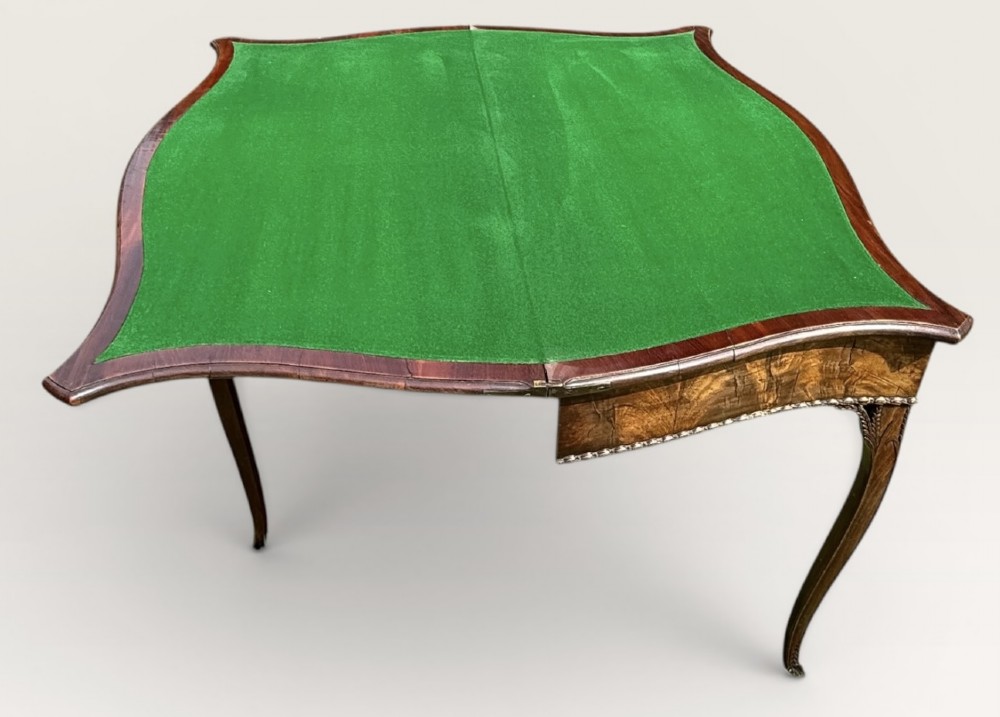 An antique warm brown mahogany card table with a serpentine front, carved cabriole legs, and a hinged fold-over top. View X
