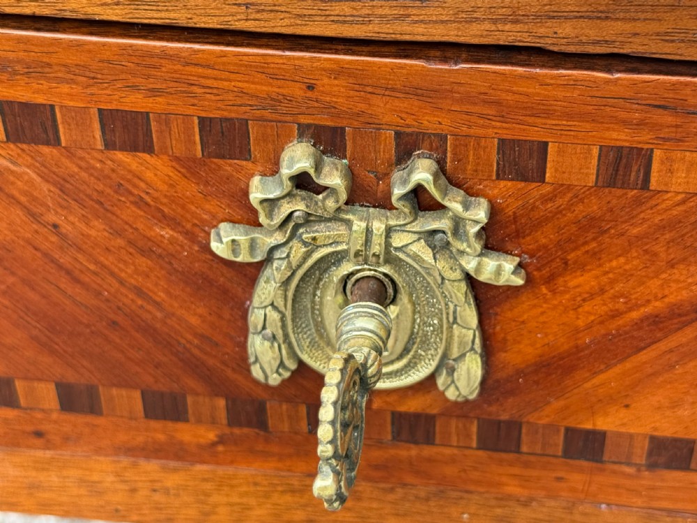 An 18th-century French Louis XVI bureau plat featuring a leather inset top, gilt bronze mounts, three frieze drawers with parquetry inlay, and square tapered legs. View VIII