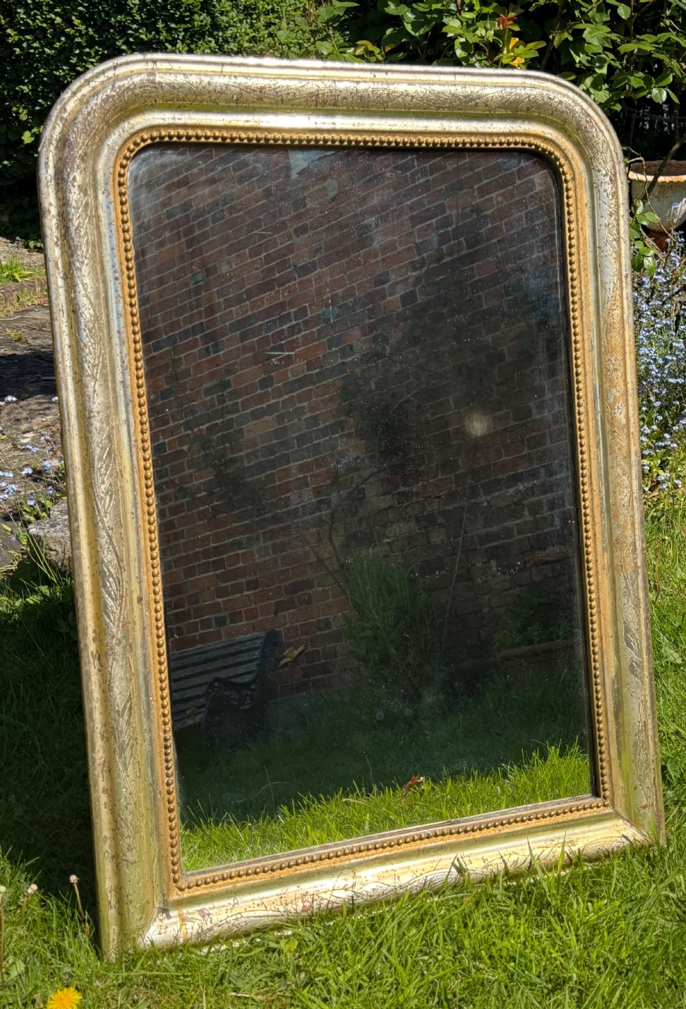 A rectangular 19th-century French Louis Philippe wall mirror featuring rounded upper corners, an inner beaded moulding, and a distressed silver gilt finish. View VIII