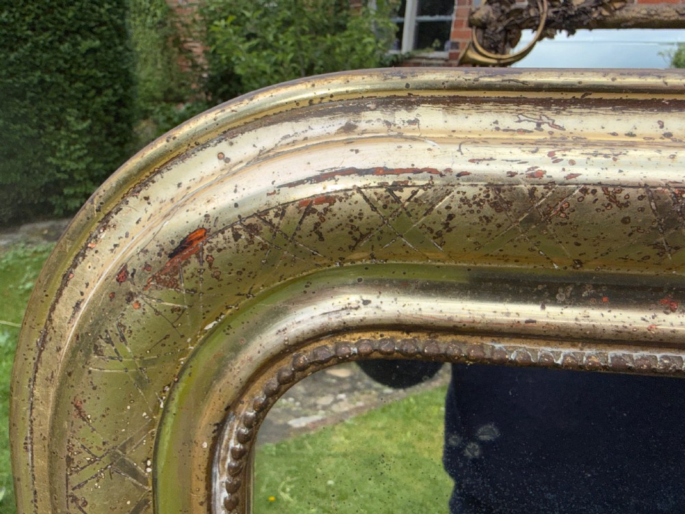 A large rectangular Louis Philippe mirror featuring rounded upper corners, a silver gilt frame with etched cross-hatch patterning, and a beaded inner border. View V
