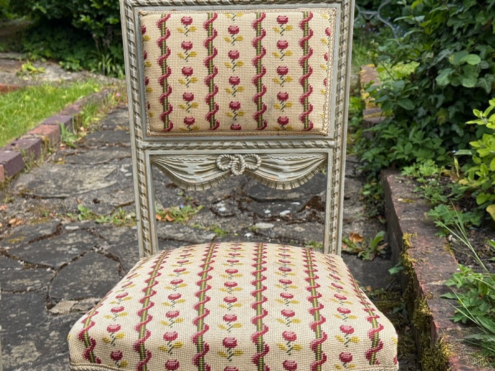 A pair of grey-painted Louis XVI style side chairs with fluted legs and floral needlepoint fabric upholstery. View II
