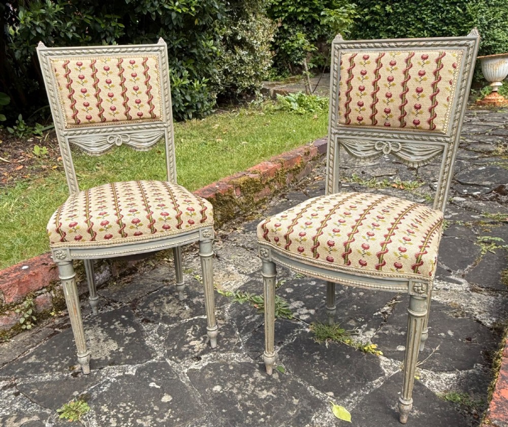 A pair of grey-painted Louis XVI style side chairs with fluted legs and floral needlepoint fabric upholstery. View III