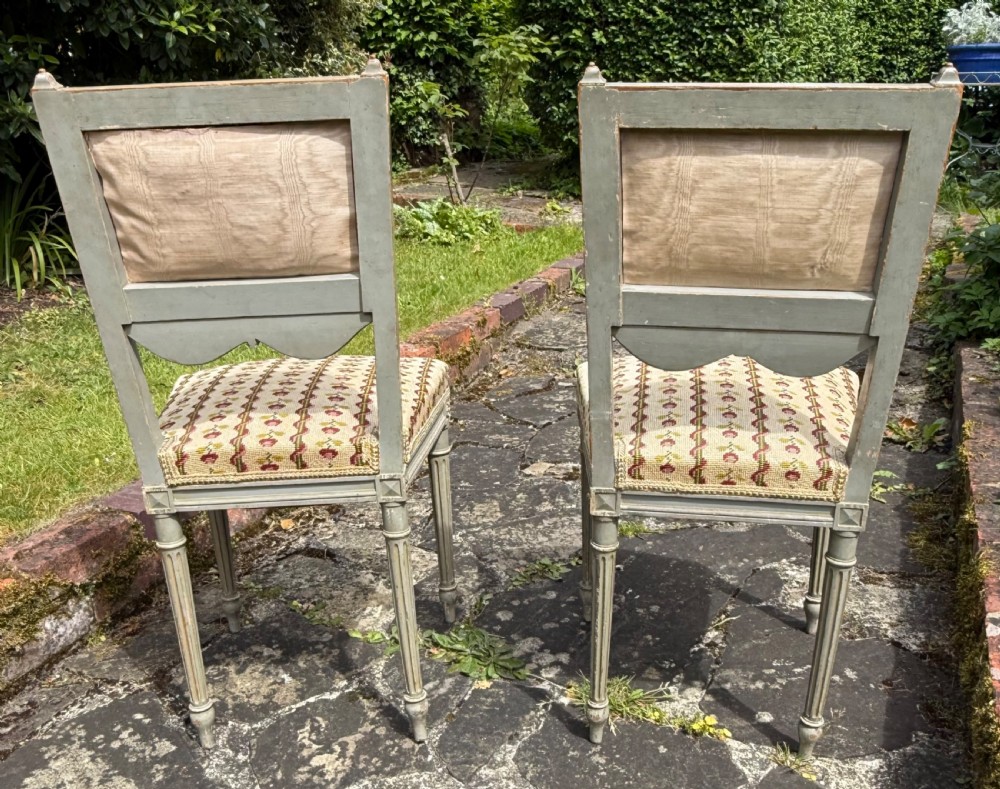 A pair of grey-painted Louis XVI style side chairs with fluted legs and floral needlepoint fabric upholstery. View IV