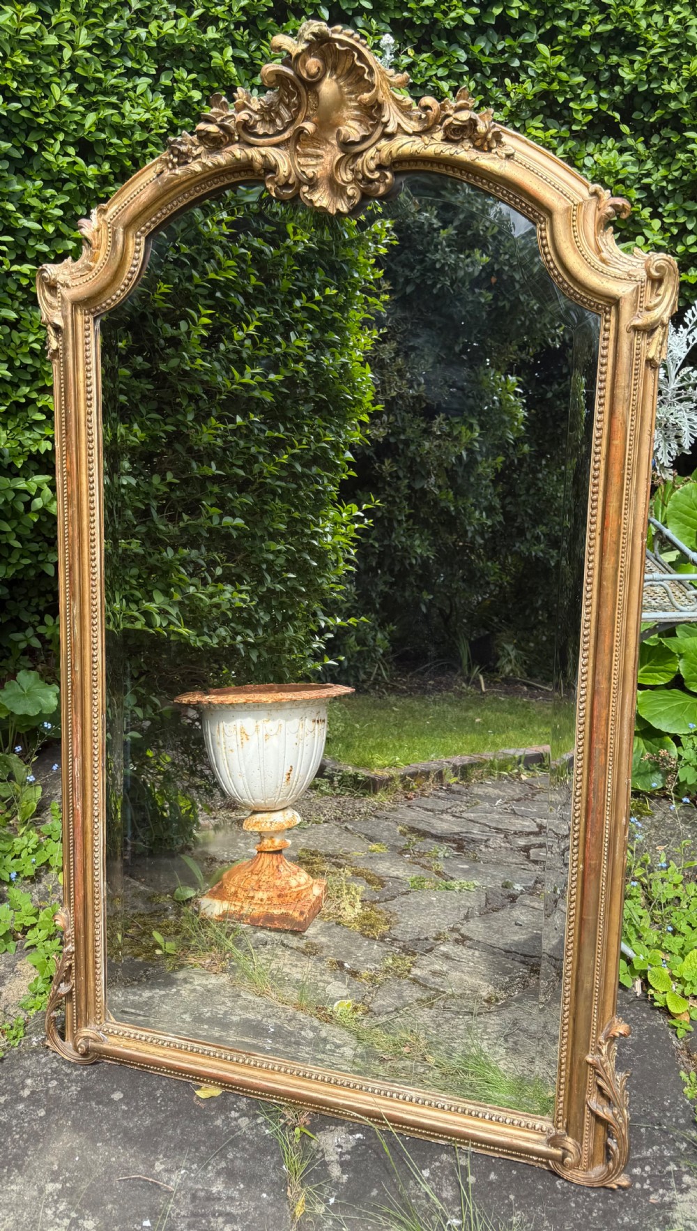 A large 19th-century arched giltwood overmantel mirror featuring a carved shell motif crest and beaded inner border. View III