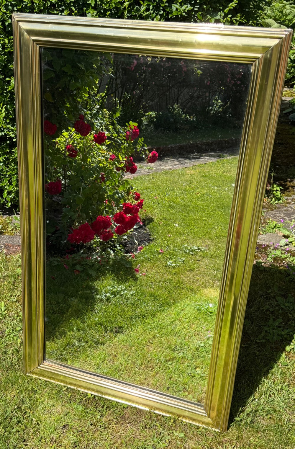 A large rectangular wall mirror featuring a polished brass frame with a wide moulded profile. View IV