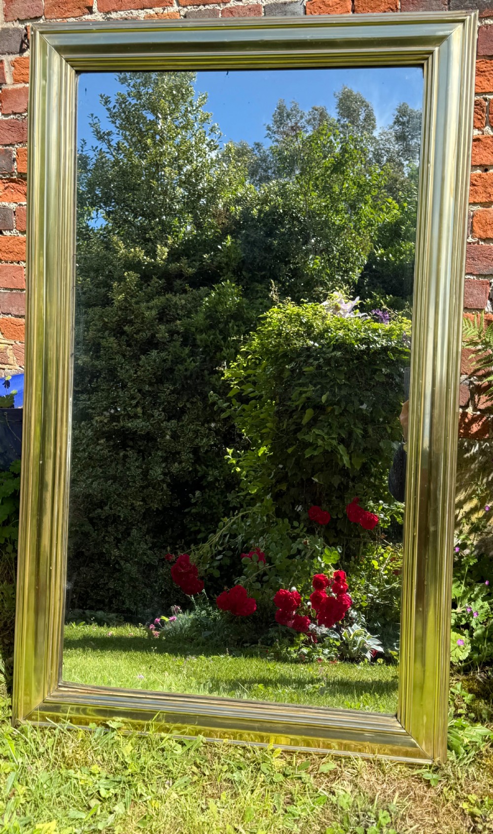 A large rectangular wall mirror featuring a polished brass frame with a wide moulded profile. View V